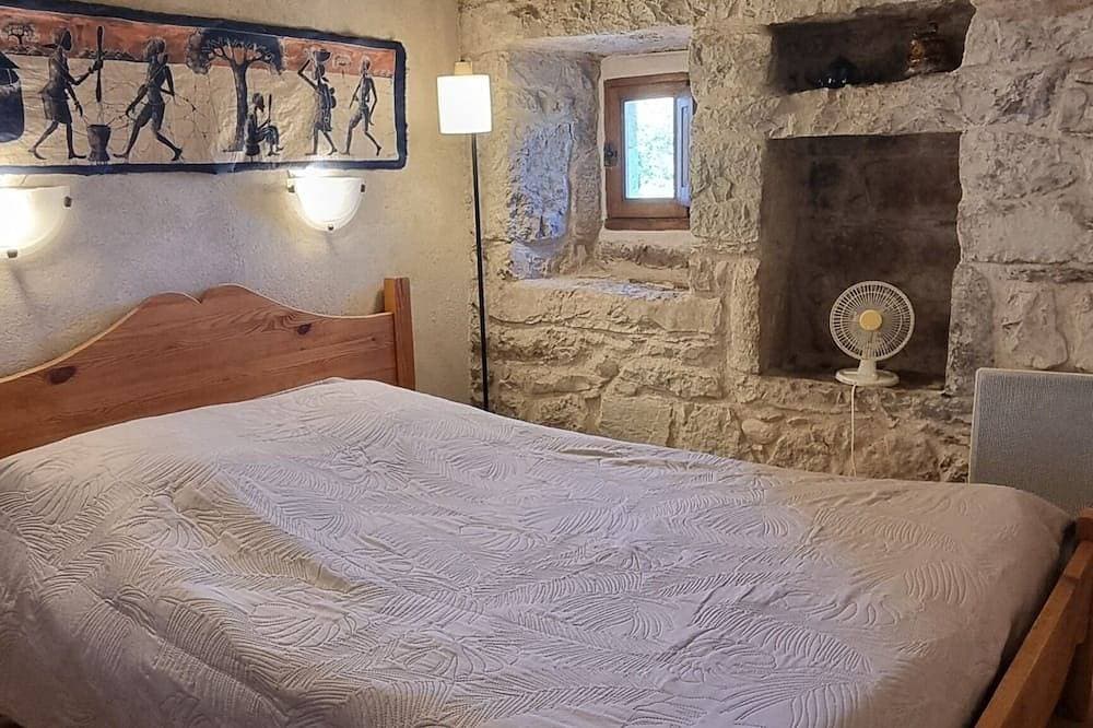 Vacation rental in a 19th-century farmhouse, exposed stone walls, pool, large wooded property 1