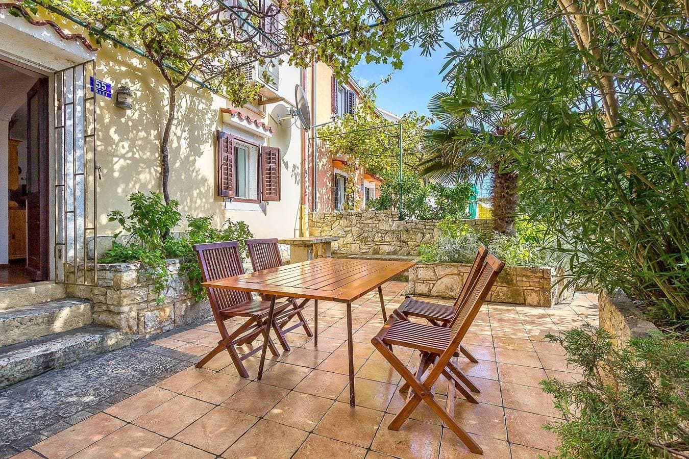 Foto 2 von 21: Komfortables Ferienhaus mit Palmen, Weinreben und Liegestühlen im Garten